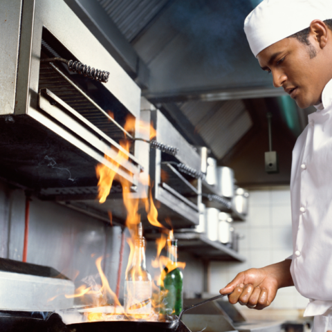 Chef cooking with fire, Intelli-Hood optic sensor in kitchen hood